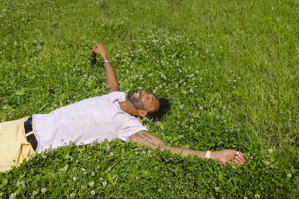 Man relaxing alone in grass at the park